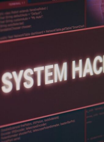 Computer monitor showing hacked system alert message flashing on screen